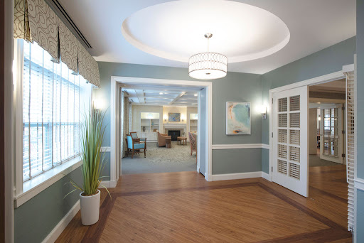 A modern lobby featuring stylish design elements, including a unique ceiling light and a spacious layout.