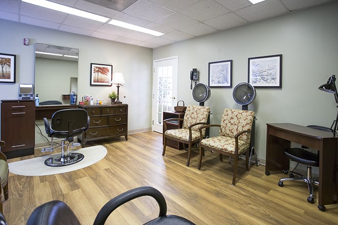 A cozy waiting room with chairs and office decor.