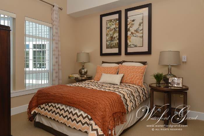 A cozy bedroom with patterned bedding and stylish decor accents.