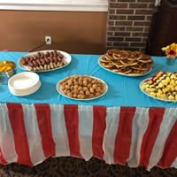 A vibrant buffet table with an assortment of appetizers and treats, perfect for a party setting.