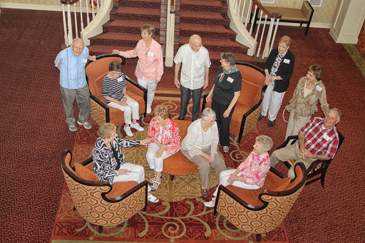 A group of seniors enjoying a social gathering in a cozy indoor setting.