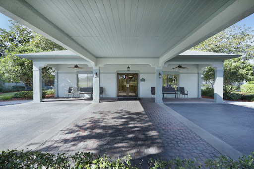 A modern commercial building entrance with a spacious outdoor area.