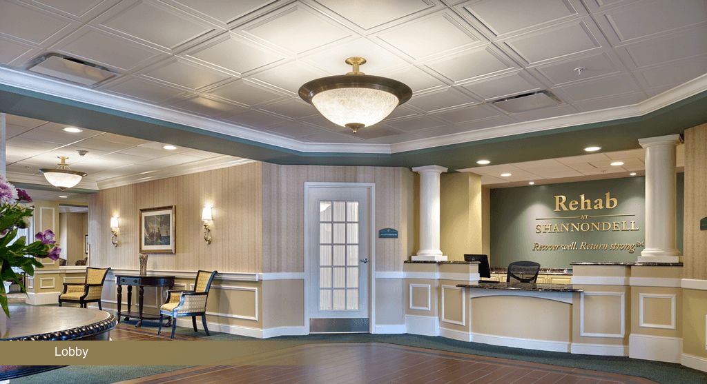 A well-decorated lobby area with a reception desk and seating.