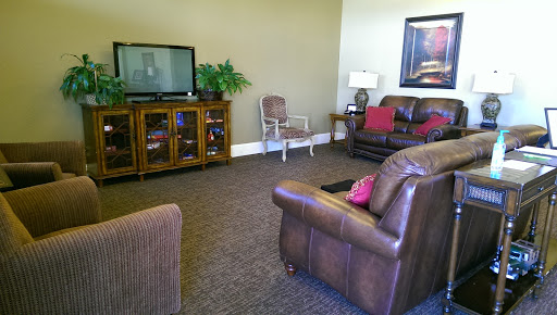 A cozy living room setup featuring brown leather furniture and a television.