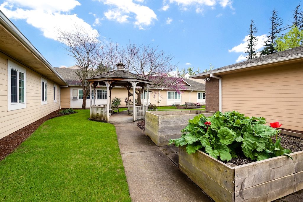 A charming house with a well-maintained garden and gazebo.