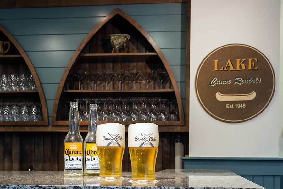A cozy bar setting with bottles and glasses of beer displayed on the counter.