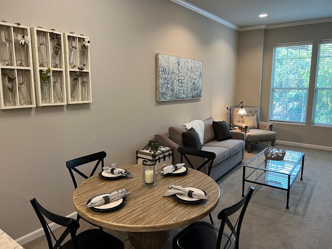 A cozy, modern living and dining area with neutral tones and stylish furnishings.