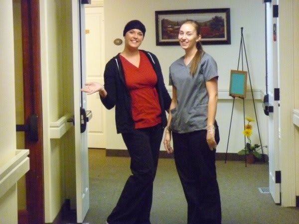 Two people smiling in a workplace setting.