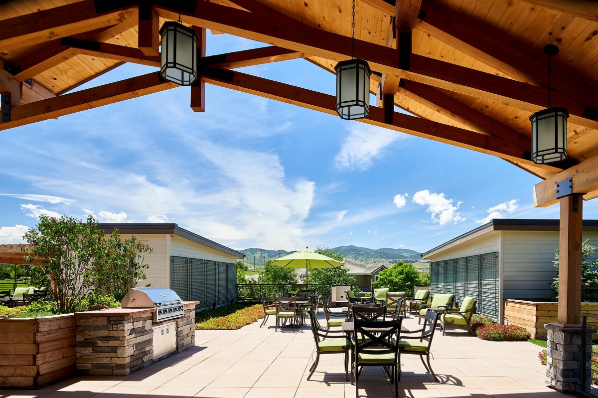 A scenic outdoor patio with seating area and mountain views.