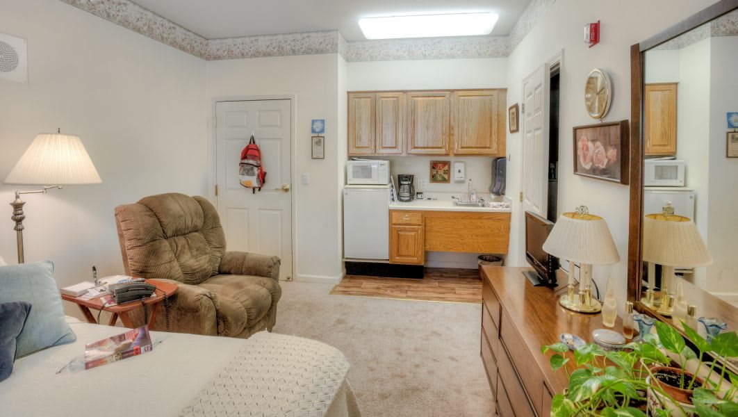 A cozy living space featuring a kitchenette and comfortable seating.