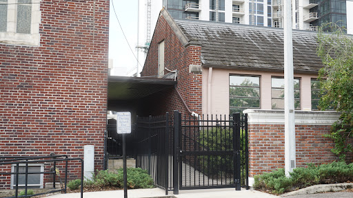 A view of a brick building with a gated entrance.