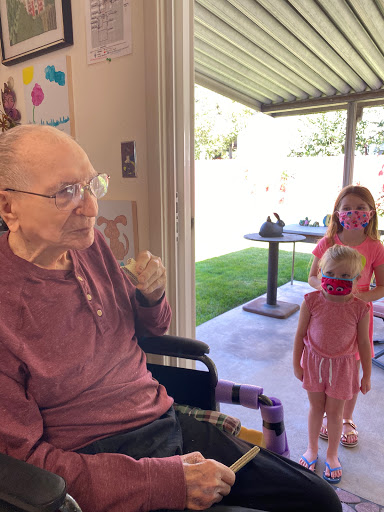 A heartwarming moment shared between an elderly person and young children, capturing the essence of family connection.