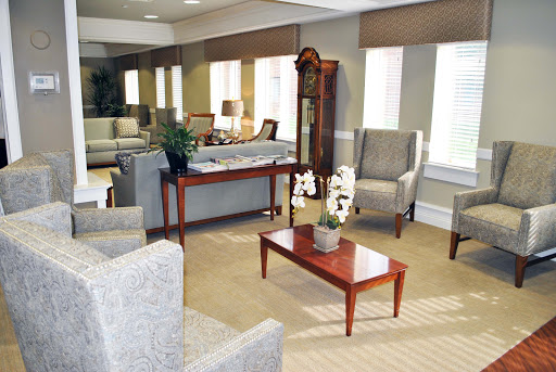 A cozy and inviting living room space with comfortable seating, a coffee table, and natural light coming through the windows.
