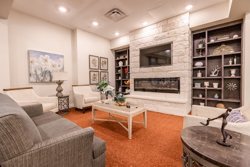 A modern living room featuring a stylish fireplace and comfortable seating.