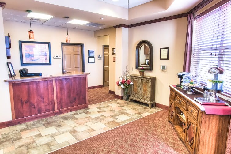 A cozy reception area with wooden furniture and warm lighting.