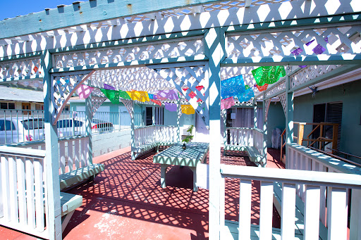 A vibrant outdoor patio adorned with colorful decorations, casting intricate shadows on the ground.