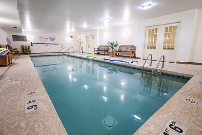 An inviting indoor swimming pool with seating areas for relaxation.