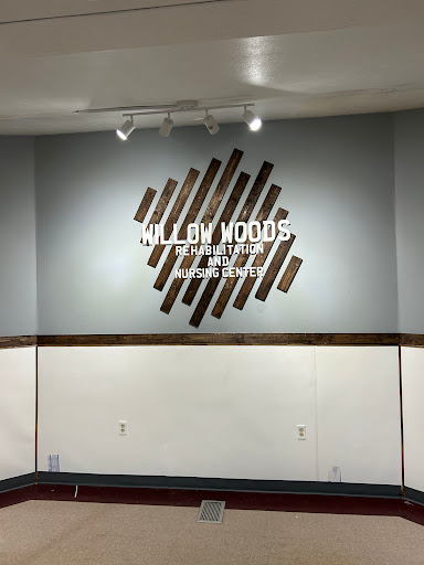 A stylish wall display featuring a wooden design with the name 'Willow Woods' prominently showcased.