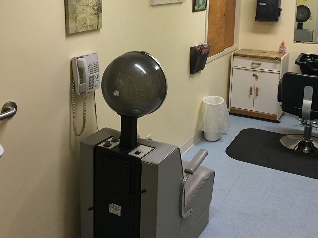 A hair salon interior featuring a vintage-style hair dryer.