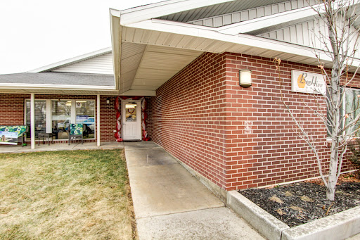 A welcoming entrance with a brick exterior and a pathway leading to the door.