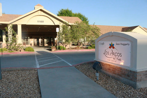 The entrance of a commercial building with landscaped surroundings.