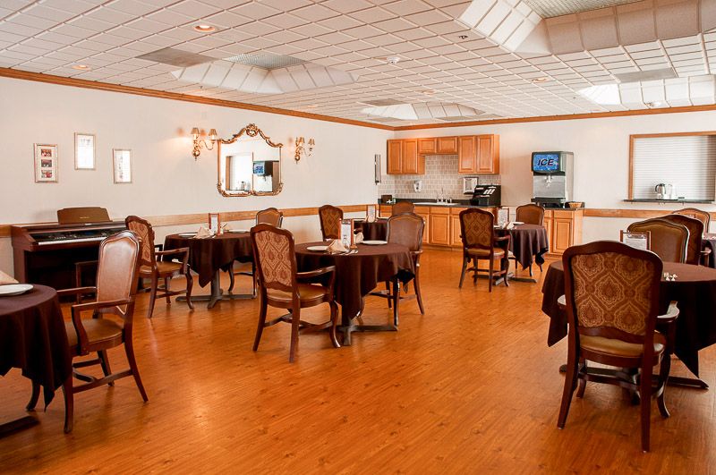 A cozy dining area with wooden floors and comfortable seating arrangements.