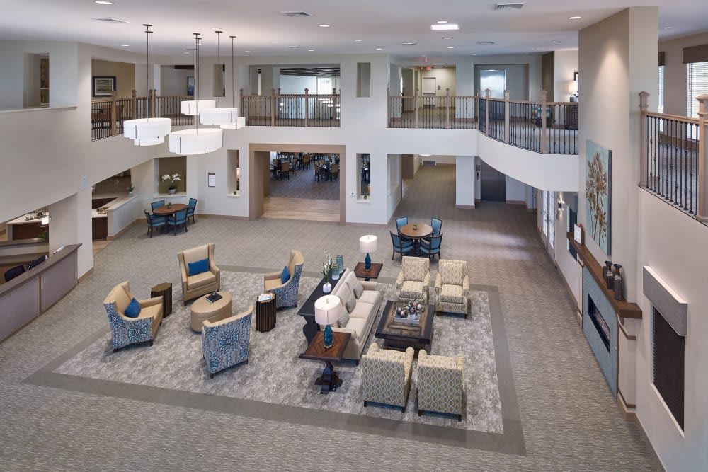 A spacious lobby with modern furniture and elegant lighting fixtures.