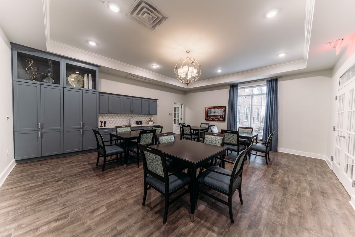 A well-appointed dining room with elegant furnishings and a chandelier.