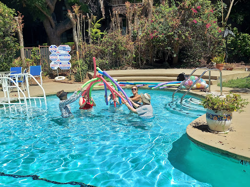Enjoying a sunny day at the pool with family and fun water activities.