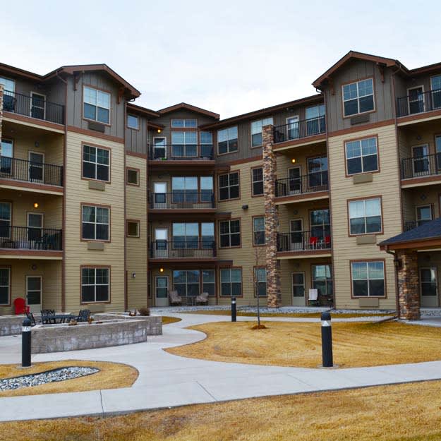 A multi-story apartment building with a courtyard area.