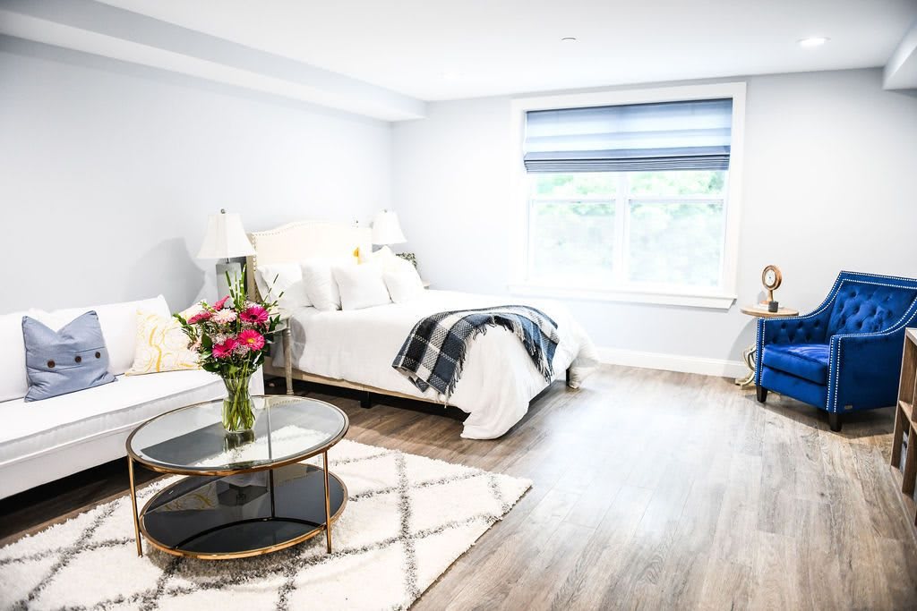 A bright and modern bedroom with minimalist decor and cozy furnishings.