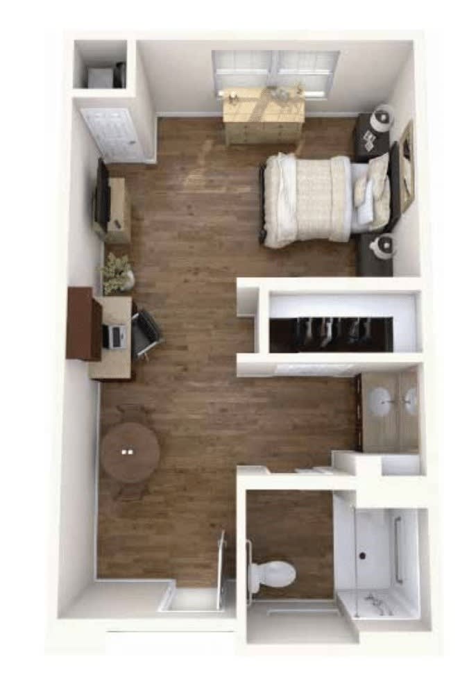 A top-down view of a studio apartment layout featuring a bed, workspace, kitchenette, and bathroom.