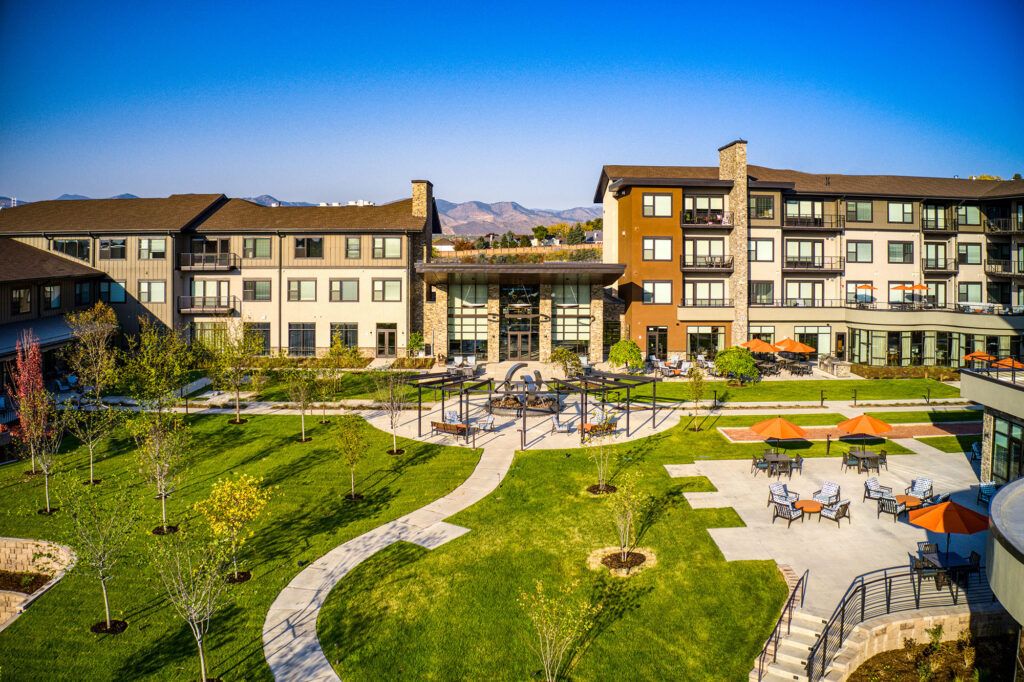 A modern residential complex with well-maintained green spaces and outdoor paths.