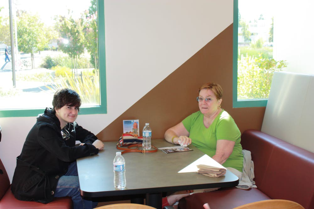 Two people sitting at a table in a restaurant.