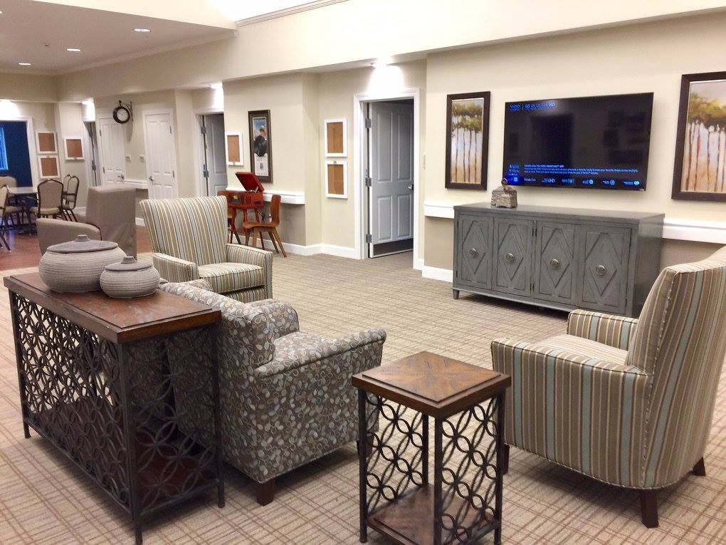 A modern living room with comfortable seating and a large television.