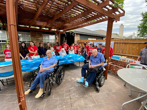 Volunteers come together to support and engage with seniors at a community event.
