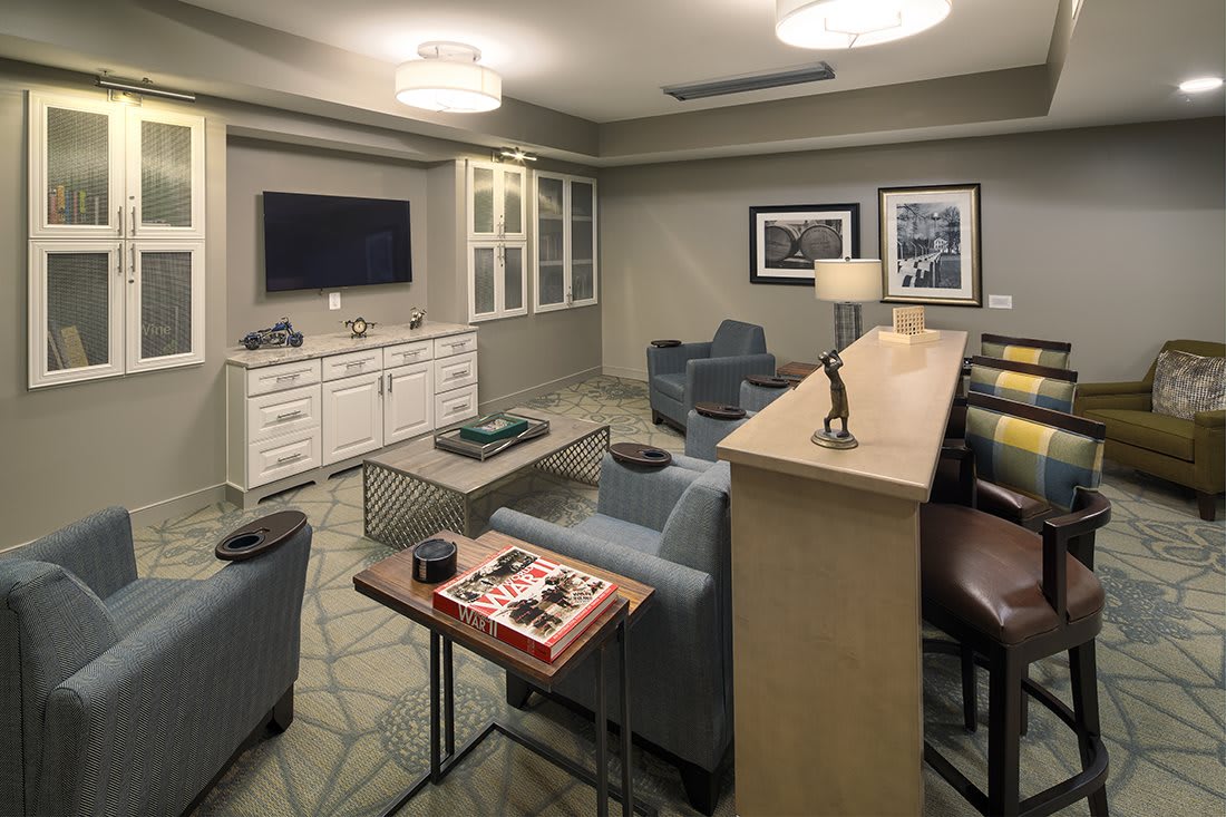A modern living room with stylish furniture and a wall-mounted television.