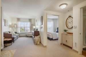 A cozy home interior featuring a living room and an adjacent bedroom, styled with modern furniture and decor.
