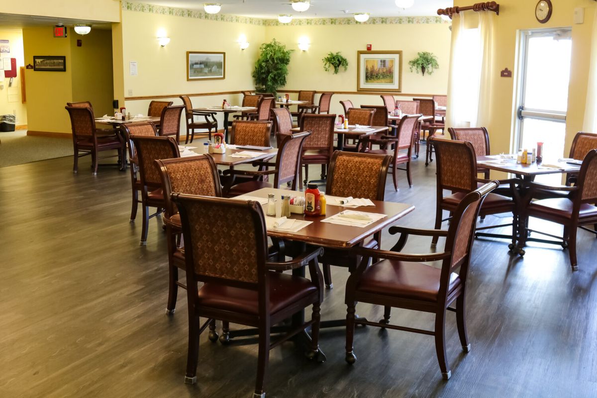 An empty dining area with neatly arranged tables and chairs.