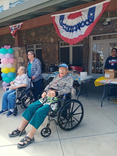 Residents enjoying a community celebration outdoors with caregivers.