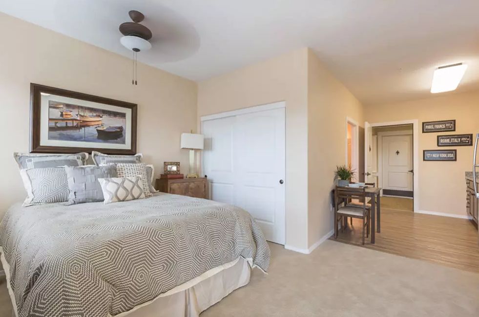 A cozy bedroom with neutral decor and elegant furnishings.