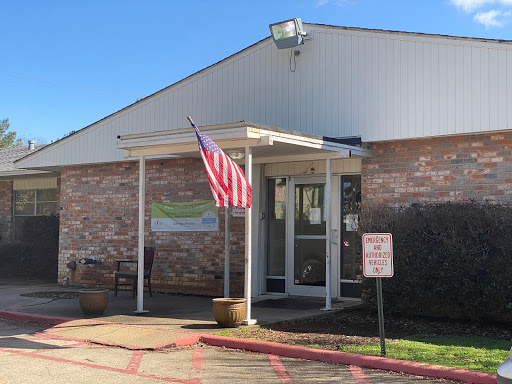 The entrance of a community building displaying an American flag.