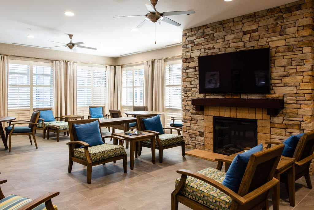 A cozy living room with comfortable seating, a fireplace, and a television.