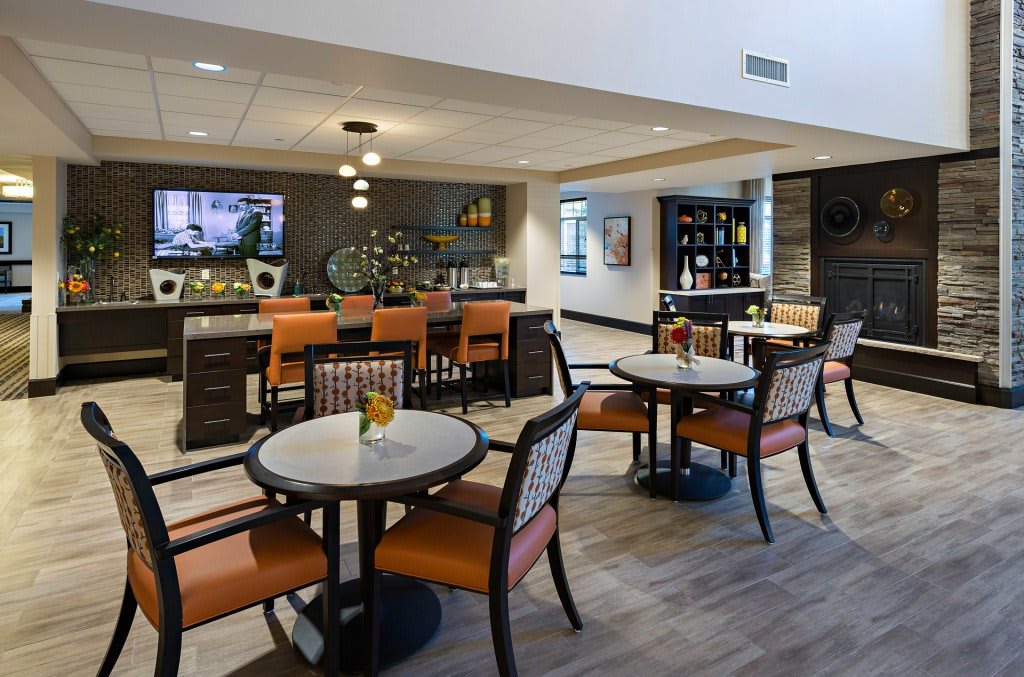 A modern lounge area with comfortable seating and a bar.