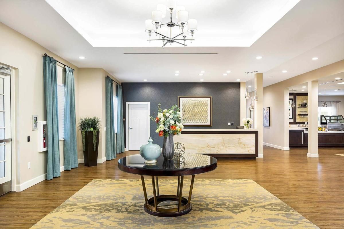 A modern lobby with a central table and elegant decor.