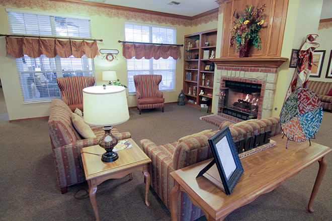 A cozy living room with a fireplace and comfortable seating.
