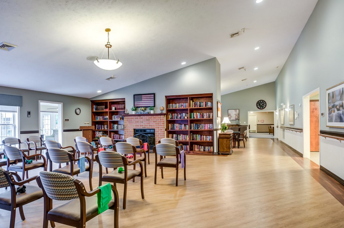 A cozy library with bookshelves and a seating area.