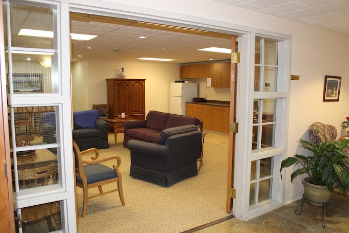 A cozy living area with various seating options and a small kitchenette.