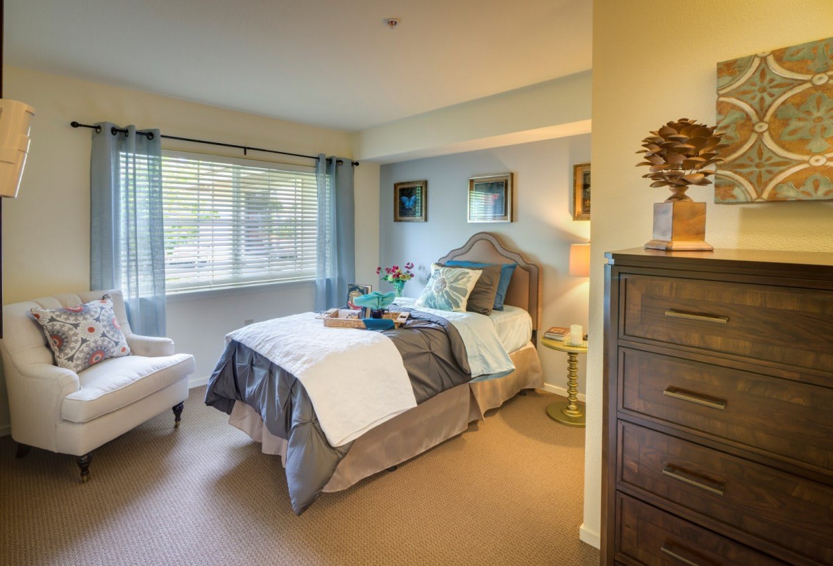 A cozy and well-decorated bedroom with a comfortable bed and natural light.