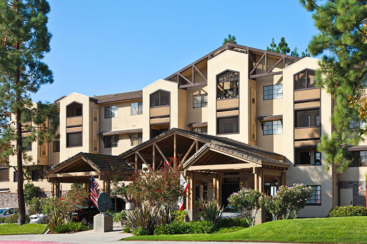 A mid-sized hotel building with a modern architectural design surrounded by landscaped gardens.